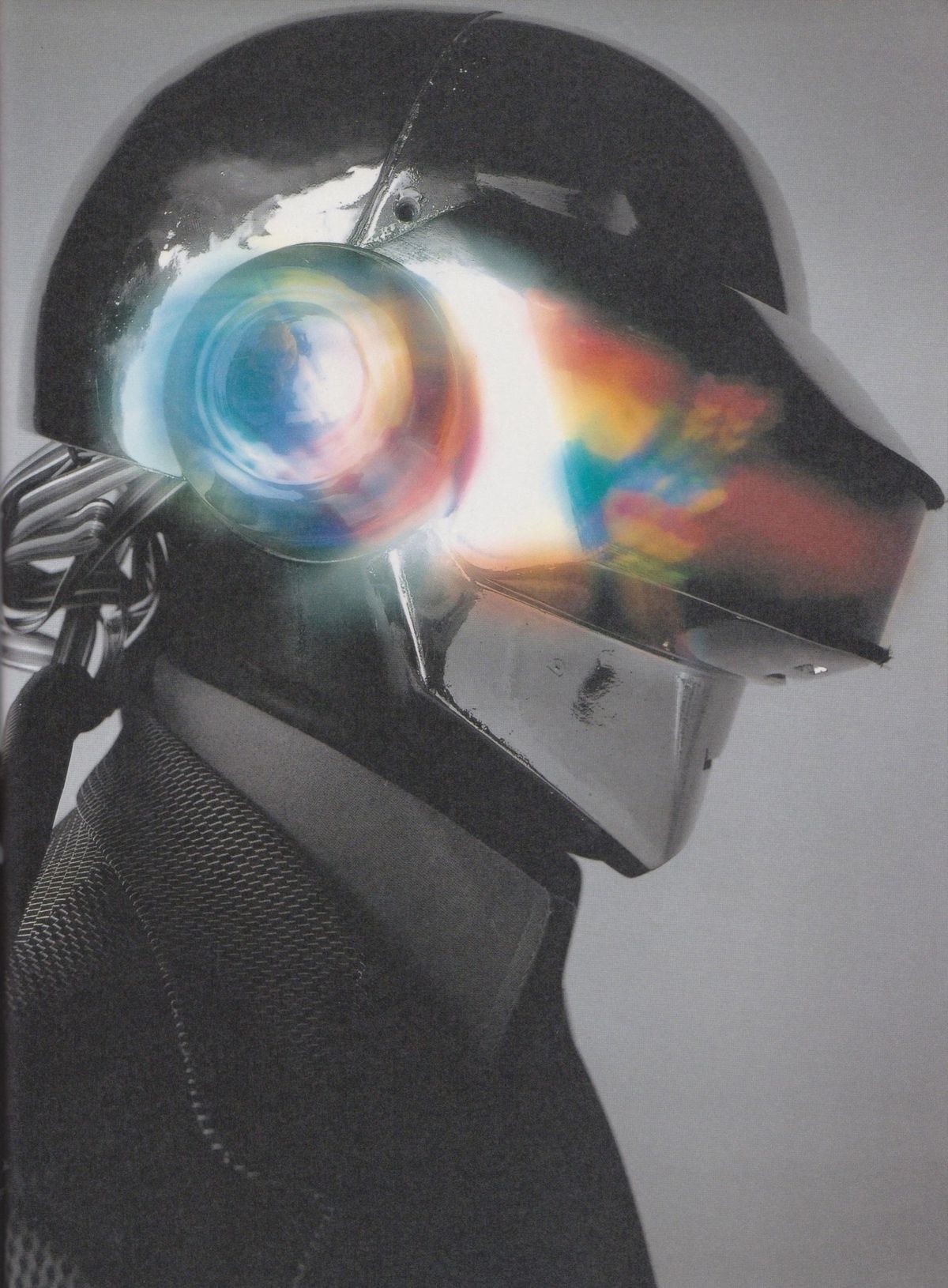 A robot-helmeted artist in profile, earcup glowing with refracted color.